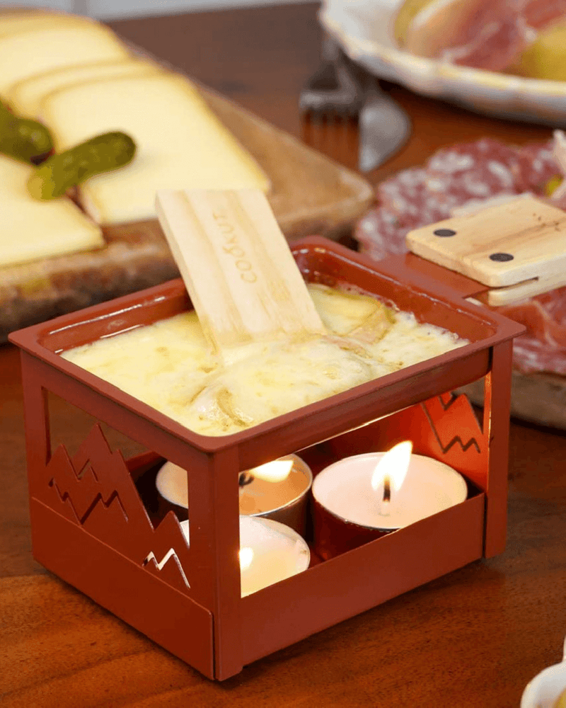 Raclette à la Bougie Pliable de Cookut, modèle compact pour fondre du fromage sans électricité, idéale pour des moments conviviaux.